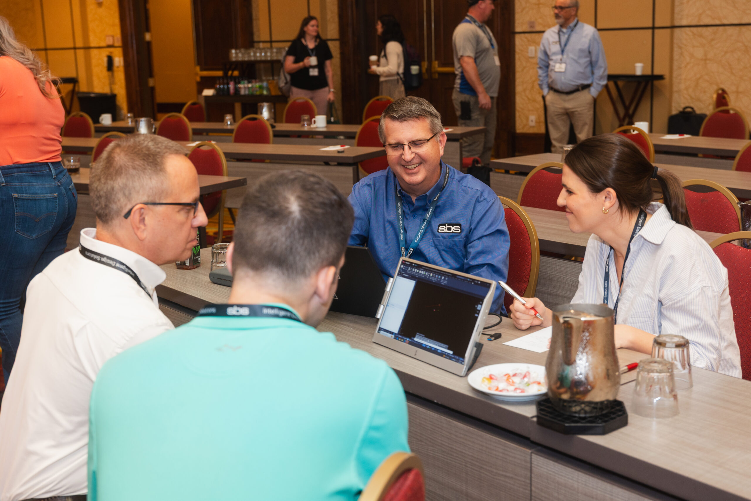 Utility industry experts discussing utility design at a conference.